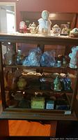 Full view of antique wood and glass display case with all contents