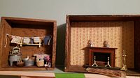 Vignette scenes in wooden box containers showing laundry scene and fireplace vignette with miniature items