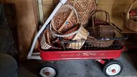 Radio Super red wagon filled with multiple woven baskets in various shapes and sizes, showing the main wagon and the baskets.