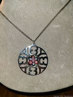 Full view of necklace displayed on bust showing chain and pendant design