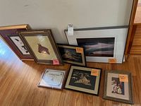 Overview of six framed artworks and one certificate, showing various framing styles and subjects
