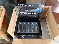 Box showing five packs of Dunlop golf balls inside a larger cardboard box