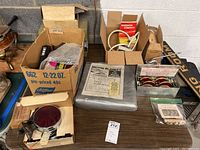 Overview photo showing several boxed items including motor blanket, reflector flares, and packaging boxes containing miscellaneous items