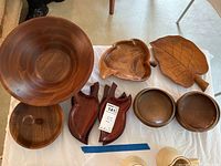 Top view of all wooden pieces showing variety of bowls and platters including leaf and apple shapes