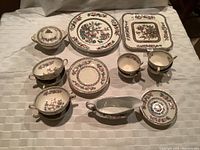 Top down image showing all pieces in the lot with visible Indian Tree pattern detailing, arranged neatly on a white tablecloth.