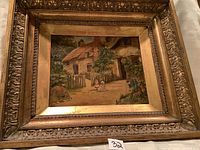 Front view of painting and ornate frame showing cottage, children, and gate.