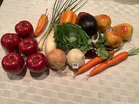 Photo showing an arrangement of realistic fake fruit and vegetables including apples, carrots, peppers, lettuce and more.
