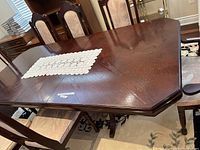 Top view of the wood dining table showing wood grain and part of the leaf extension