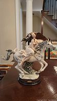Full front view of entire porcelain figurine on table