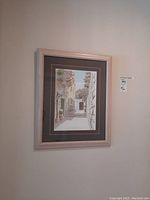 Framed original pen ink artwork photograph showing full frame and artwork.