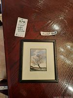 Photo showing the framed miniature painting depicting a solitary bare tree in a landscape, with labels indicating "Original mixed media miniature" and size "A4x3F 8x7".