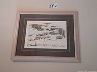 Framed pen ink drawing displayed on wall with label showing size and lot information.