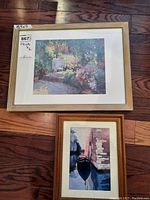 Top view of the larger framed garden scene print with light wood frame and white mat