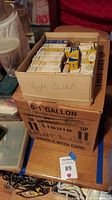 View of two boxes stacked containing multiple smaller boxes of light bulbs labeled 'Light Bulbs'.