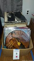 Box filled with vinyl records including a Michael Jackson picture disc prominently placed in front.