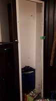 Front view of the vintage wooden wardrobe showing the full-length mirror on the door.