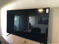 Front view of TV on stand showing full screen and bezel