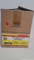 Photo of the trowels in original box showing labeling that specifies 3/32" x 3/32" x 3/32" square notch Pro Floor Trowels - pack of 12 pieces.