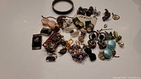 Photo of large lot of vintage earrings and other jewelry including various styles and colors