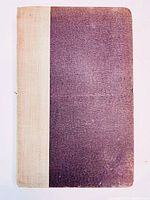 Photo of the front cover showing dark purple textured surface with light beige cloth spine.