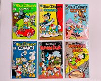 Six Walt Disney comic books laid out in two rows of three, showing colorful covers featuring Donald Duck, Mickey Mouse, and other characters.