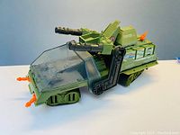 Front side view of the main green H.A.V.O.C. vehicle showing weapons and windshield