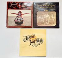Front view of three vinyl album covers laid out: Decade by Neil Young, Deja Vu by Crosby, Stills, Nash & Young, and Harvest by Neil Young