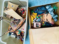 Image of a large bin containing a vintage Playmobil ship with sails and numerous figures and accessories inside.