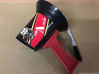 Side angle of the black plastic megaphone with red handle, showing A-Team decal featuring Mr. T and the team logo