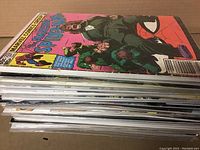 Side view photo showing the stacked comics in bags and boards