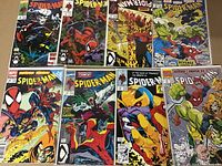 Top view of 8 high grade Spider-Man comics bagged and boarded, showing various dynamic cover arts.