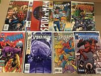 Eight Spider-Man comic books displayed flat showing front covers, vibrant color, bagged and boarded.
