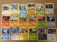 Photo showing 18 rare Pokémon cards laid out on a surface, including various types and star rarity symbols, some holographic.