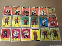 Full view of all 18 hockey cards laid out showing various players and teams including Bruins, Black Hawks, Canadiens and Maple Leafs. Cards feature colorful backgrounds and are in excellent condition with sharp corners and clean borders.