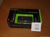 3M MPro120 pocket projector in original packaging with plastic window and bilingual text.