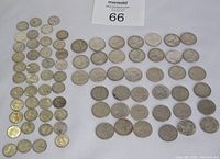 Top-down view showing all dimes and quarters arranged on a white background
