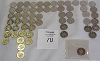 Overview of the Canadian half dollar coin collection including one sealed coin in packaging.