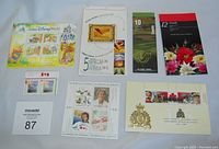 Comprehensive overview of the assortment of Canadian postage stamps including booklets and sheets such as Millennium Collection, RCMP, flowers, and others.