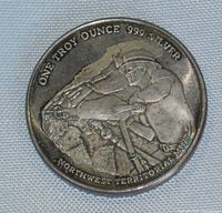 Close-up of the silver coin front side showing miner and inscription.