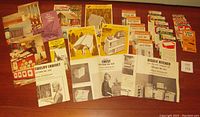 Group photo showing various leaflets for vintage build-it-yourself home and furniture projects from the 1950s-1960s, including chest, kitchen, and jewelry cabinet projects.