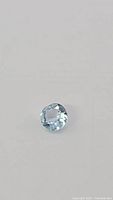 Close-up photo of the natural sky blue topaz gemstone showing its faceting and diamond cut style.
