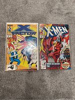 Two X-Men comic books placed on a surface, showing front covers.