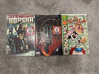 Photo showing three comics: Star Wars War of the Bounty Hunter, Alien, and Ren & Stimpy arranged side by side.