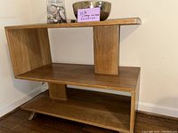 Front view of one side table showing two-tier open design and central vertical support