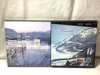 Front covers of the 1997 and 2001 Canada Post Annual Stamp Collection Yearbooks, showing scenic photographic artwork and the year prominently on the books.