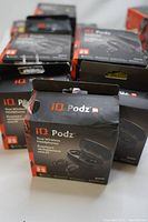 Multiple boxed iQ Podz earbuds showing front packaging with model and features