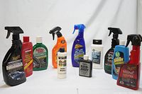 Image showing a set of 12 various car and household cleaning bottles lined up side by side.