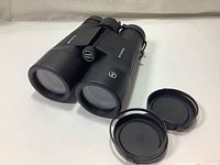 Perspective showing the binocular lenses with covers removed and placed beside them.