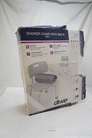 Boxed Drive Deluxe Aluminum Shower Safety Bath Chair showing brand, model, and features.