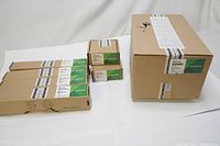 Various boxed Lexmark printer parts including large fuser box and smaller roller boxes with product labels.